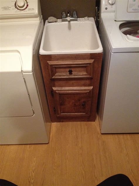 small laundry sink with cabinet